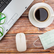 Laptop, glasses, coffee mug, mouse and face mask